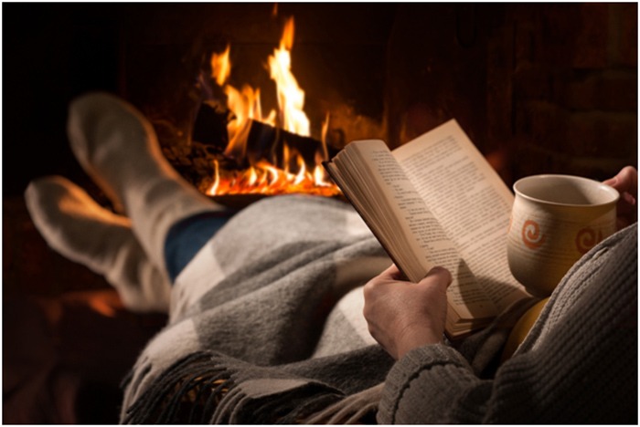 reading a book by a cozy fire